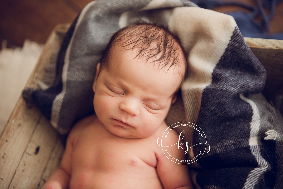 Iowa Newborn baby boy during newborn portraits with family photographed by IA Newborn and Family photographer  KS Photography