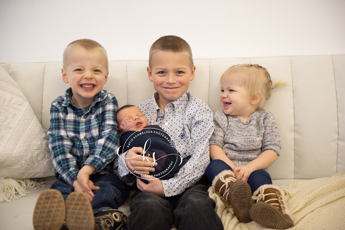 Iowa Newborn baby boy during newborn portraits with family photographed by IA Newborn and Family photographer  KS Photography